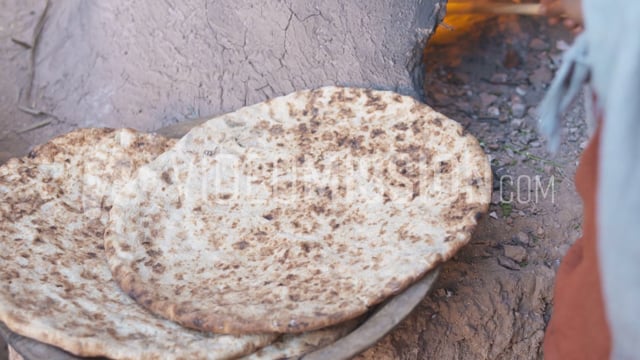 Woman Turns Flatbread In Oven And Pulls Out