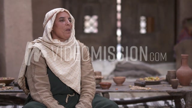 Woman Telling A Story Near A Table Of Food 2