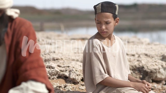 Young Boy Looks At Mans Back