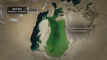 Satellite view of the Aral Sea. A gray box in the top left corner has text that reads "Aral Sea, Kazakhstan-Uzbekistan" To its right is a light gray box that has the year "2000" in it. Text toward the right reads "The lake never recovered from the projects."
