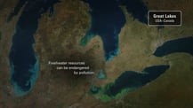 Satellite image of algae bloom in Lake Erie. A gray box in the top right corner has text that reads "Great Lakes, USA - Canada." Text toward the bottom center left reads "Freshwater resources can be endangered by pollution."