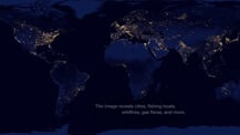 Image of night lights on Earth. Text toward the bottom reads "The image reveals cities, fishing boats, wildfires, gas flares, and more."