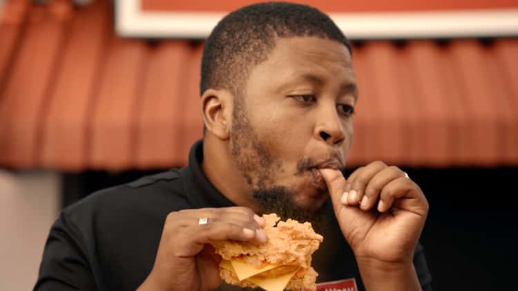 black man eating chicken kfc