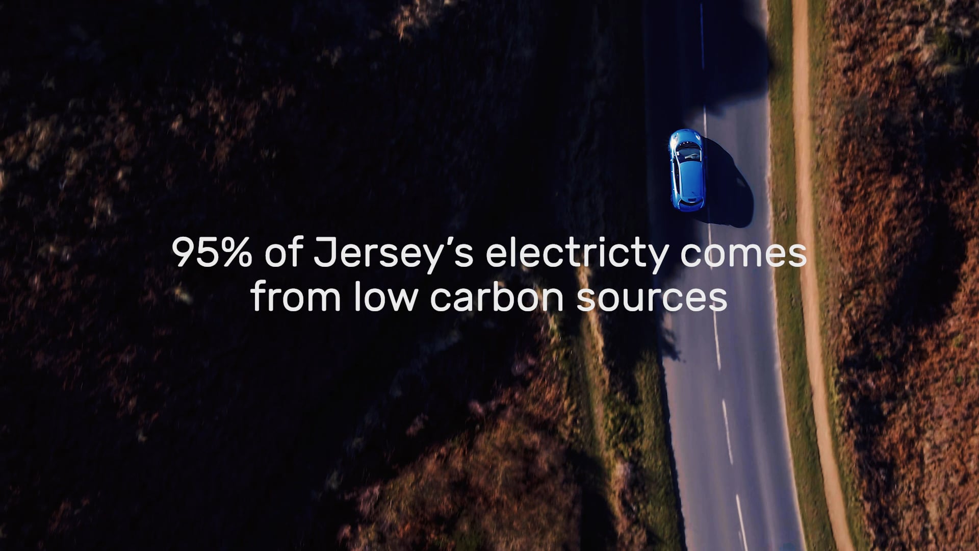 Nissan Leaf driving across causeway at Corbiere
