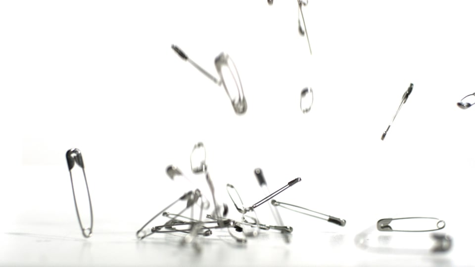 Safety pins falling and bouncing Video from Pikwizard