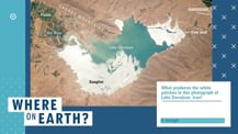 Against a blue background is a satellite image of a lake with labeled features. To the lower right of the image is a white box with text. Toward the bottom left corner is the "Where on Earth?" logo.