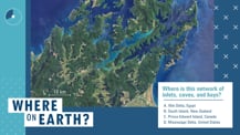 Against a blue background is a satellite image of a section of New Zealand. To the lower right of the image is a white box with text. Toward the bottom left corner is the "Where on Earth?" logo.