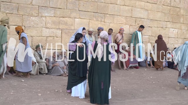 People Sitting By City Gate