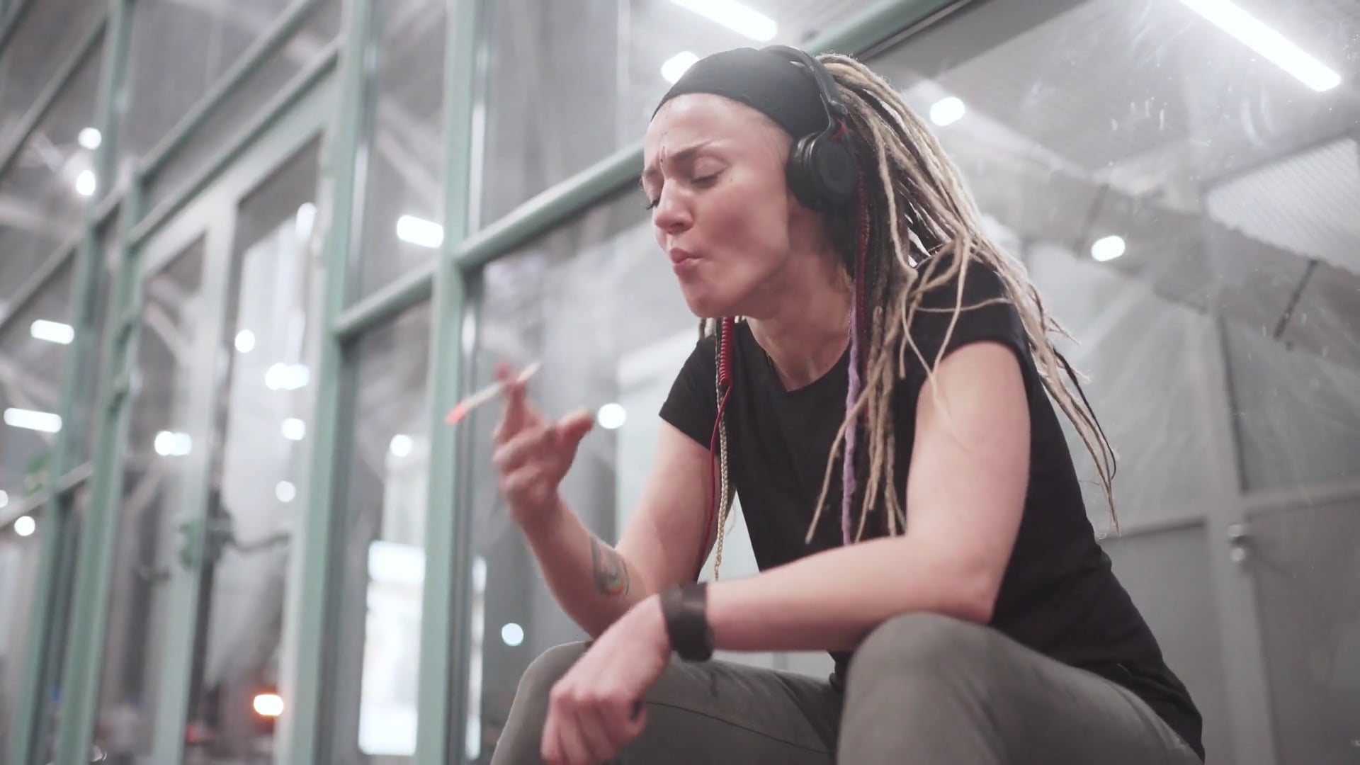 videoblocks-beautiful-stylish-young-woman-with-dreadlocks-smoking ...
