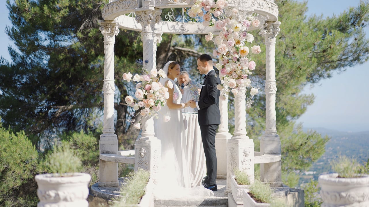 Aneke and Marseille beneath a floral ceremony arch in France