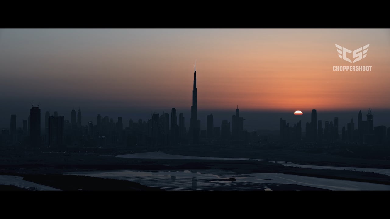The Dubai skyline and Burj Khalifa in silhouette at sunset, from ChopperShoot's Dubai aerial film