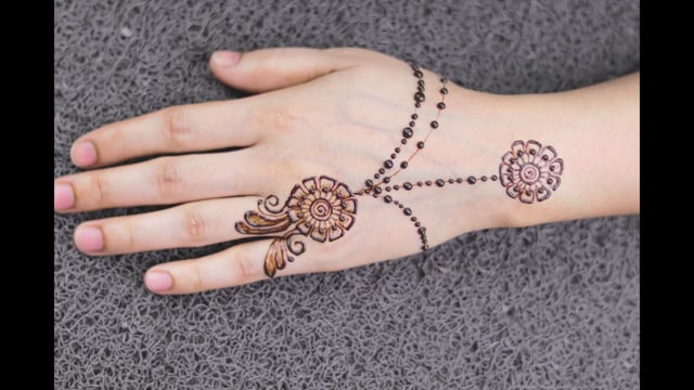 Premium stock video - Mehndi henna tattoo decoration on hands