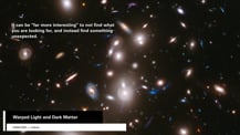 Image of many distant galaxies. A gray box in the bottom left corner has text that reads "Warped Light and Dark Matter." Text in the top left corner reads "It can be "far more interesting" to not find what you are looking for, and instead find something unexpected."